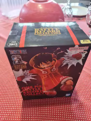 Caja original de la figura de colección Monkey D. Luffy - Moment of Battle (Versión Banpresto), con diseño oficial de Bandai Namco y detalles del producto.